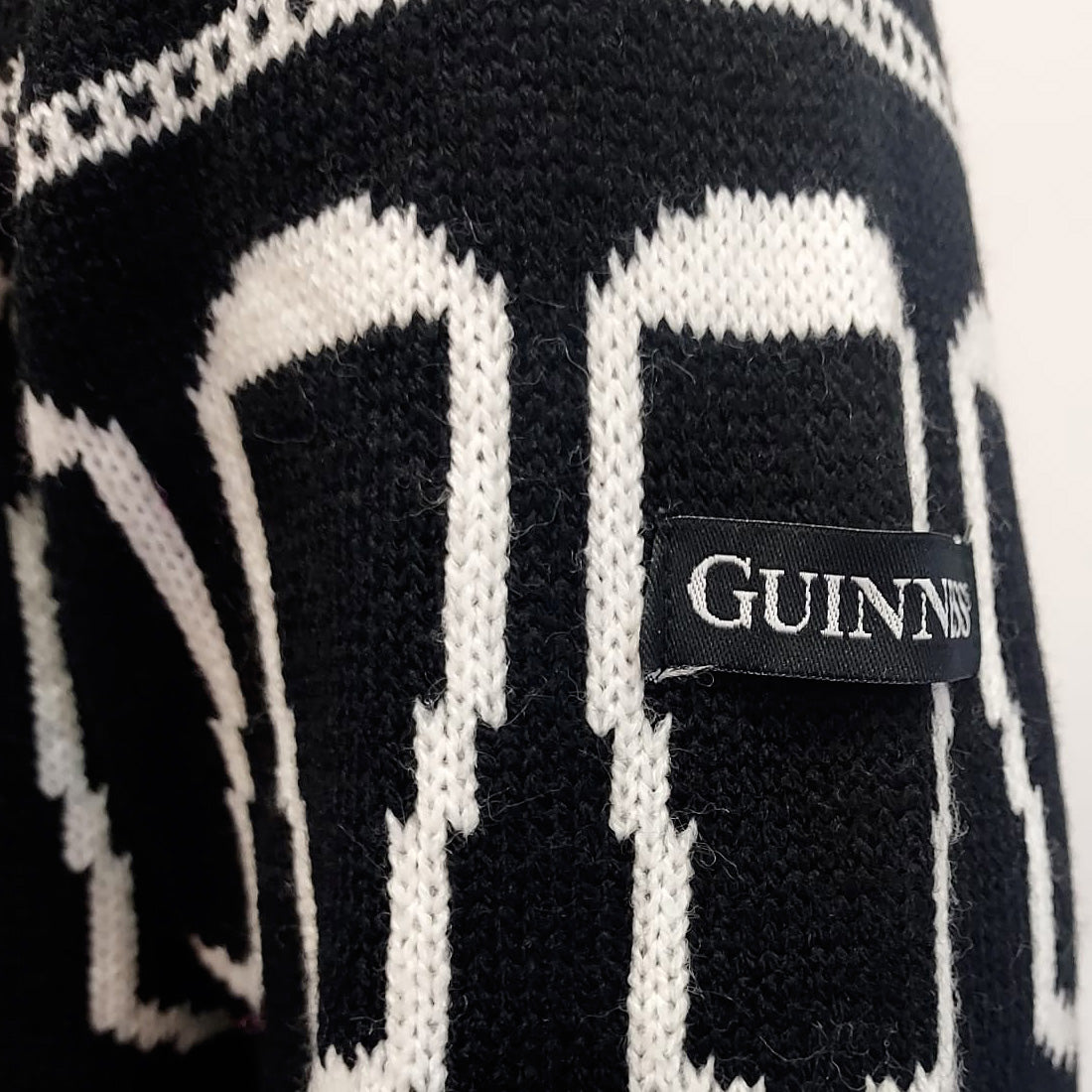 Close-up of Guinness pint design on knitted Christmas jumper